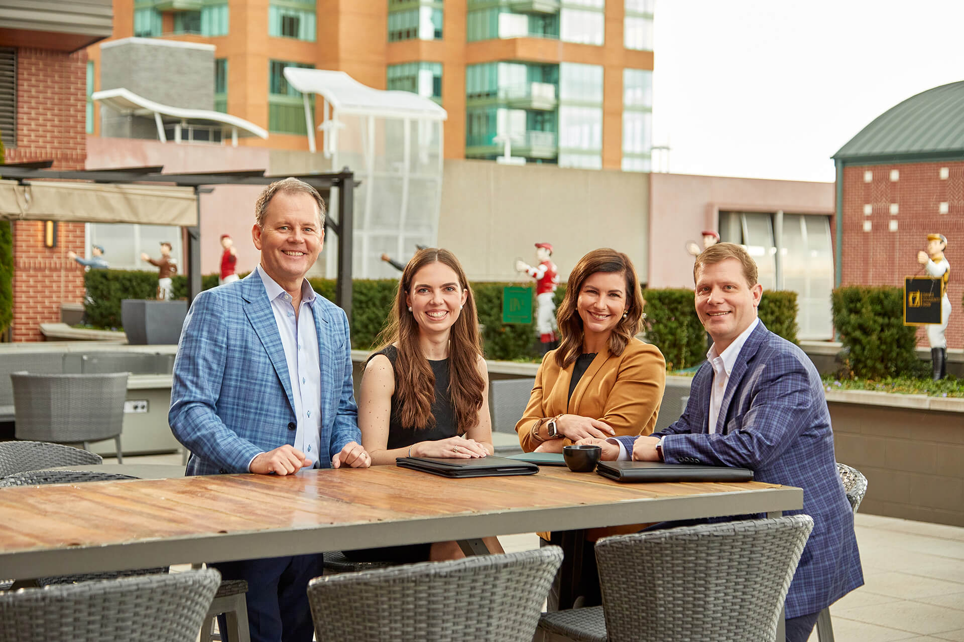 Four associates from the Wealth and Family Office team around a courtyard table